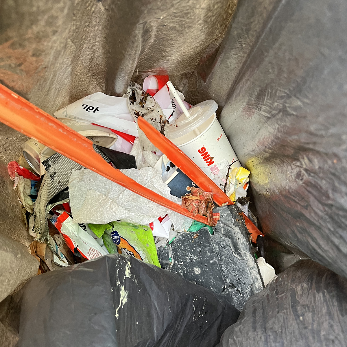 Skräp i en grå sopsäck